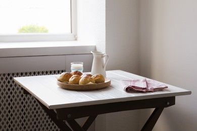 Photo of Buns and milk on table in studio. Professional food photography