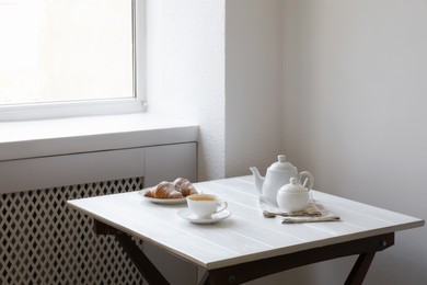 Croissants and tea on table in studio. Professional food photography