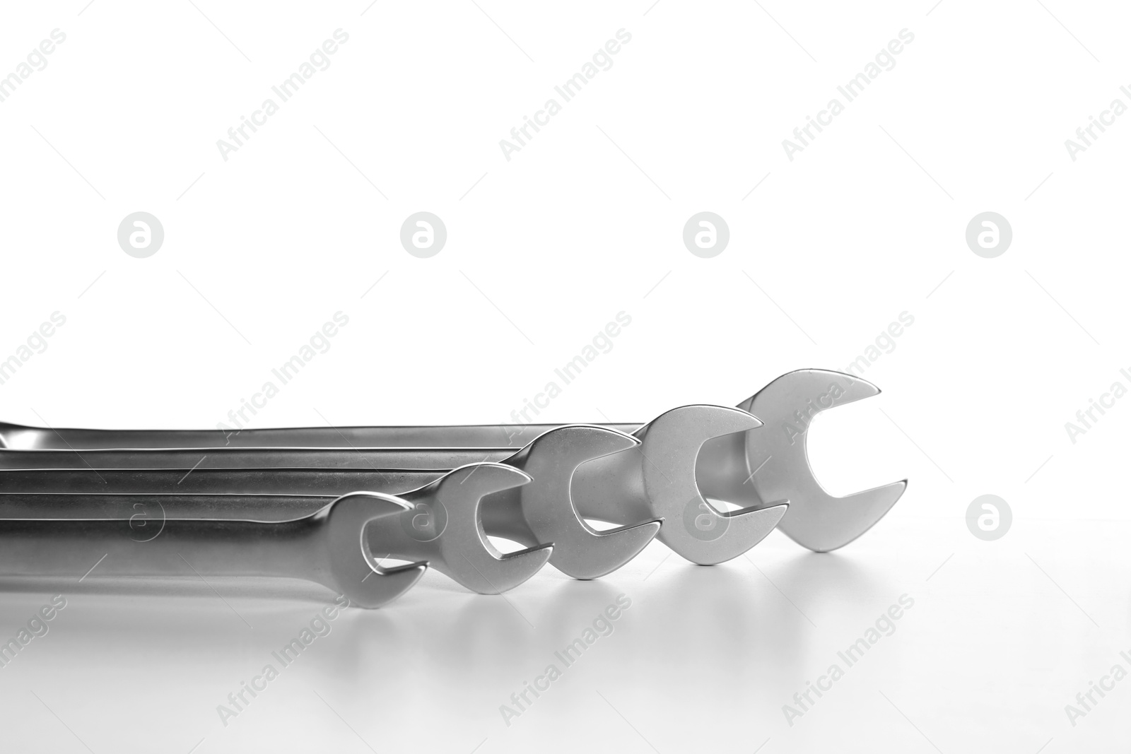 Photo of Set of ratcheting wrenches on white background. Auto mechanic tools