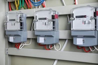 Photo of Electric meters and wires in fuse box. Energy measuring device