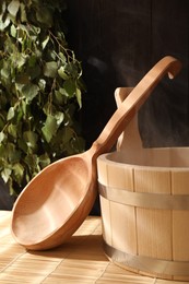 Photo of Sauna equipment. Bucket and ladle on bamboo bench