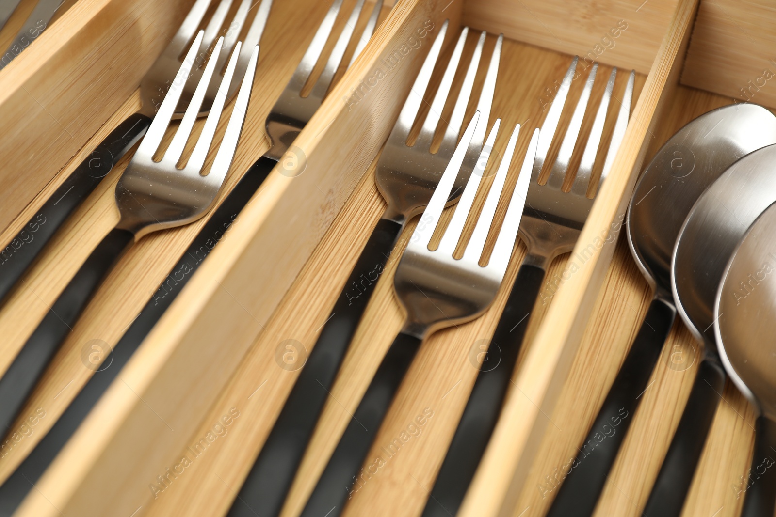 Photo of Box with cutlery in drawer, closeup. Kitchen utensils storage