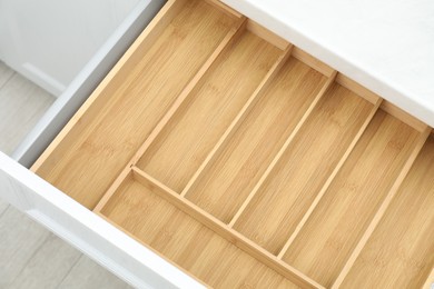 Photo of Open drawer of kitchen cabinet with space for cutlery, above view