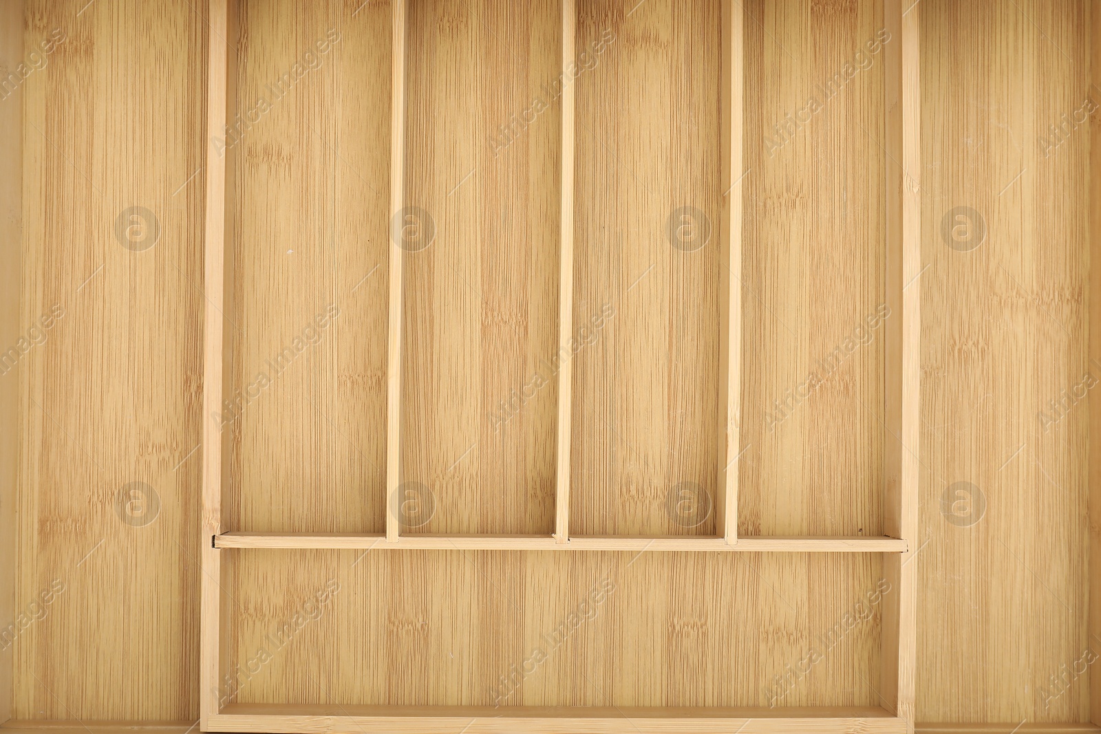 Photo of Open drawer of kitchen cabinet with space for cutlery, top view