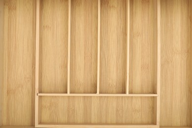 Photo of Open drawer of kitchen cabinet with space for cutlery, top view