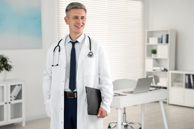 Photo of Doctor with stethoscope and clipboard in clinic, space for text