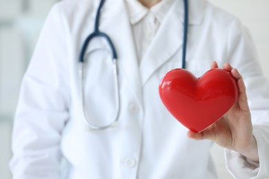 Doctor with red heart in clinic, closeup