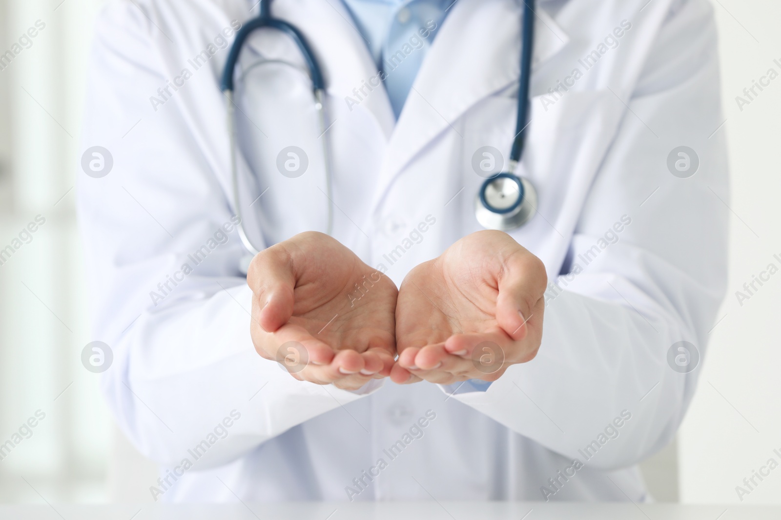 Photo of Doctor holding something in clinic, closeup view