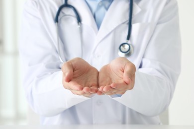 Photo of Doctor holding something in clinic, closeup view