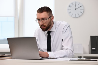 Man with poor posture working in office