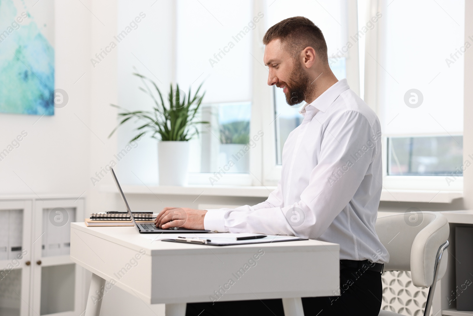 Photo of Man with good posture working in office