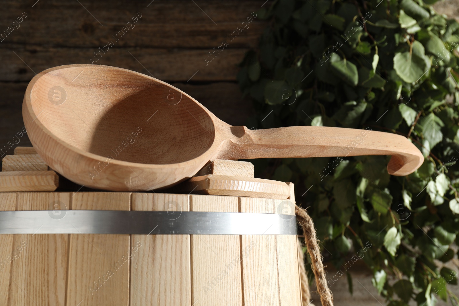 Photo of Sauna equipment. Wooden bucket and ladle indoors, closeup