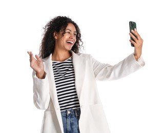 Photo of Beautiful woman in stylish jacket taking selfie on white background