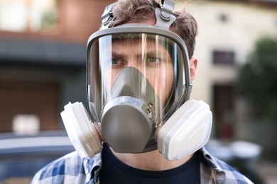 Photo of Man in respirator mask outdoors. Safety equipment