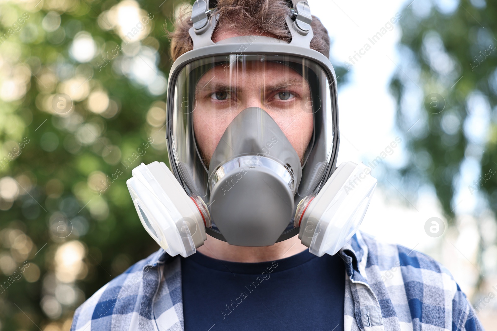 Photo of Man in respirator mask outdoors. Safety equipment