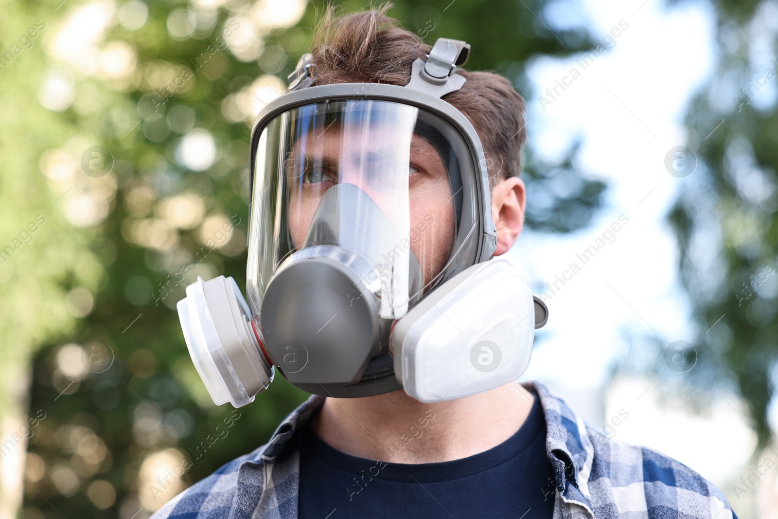 Photo of Man in respirator mask outdoors. Safety equipment