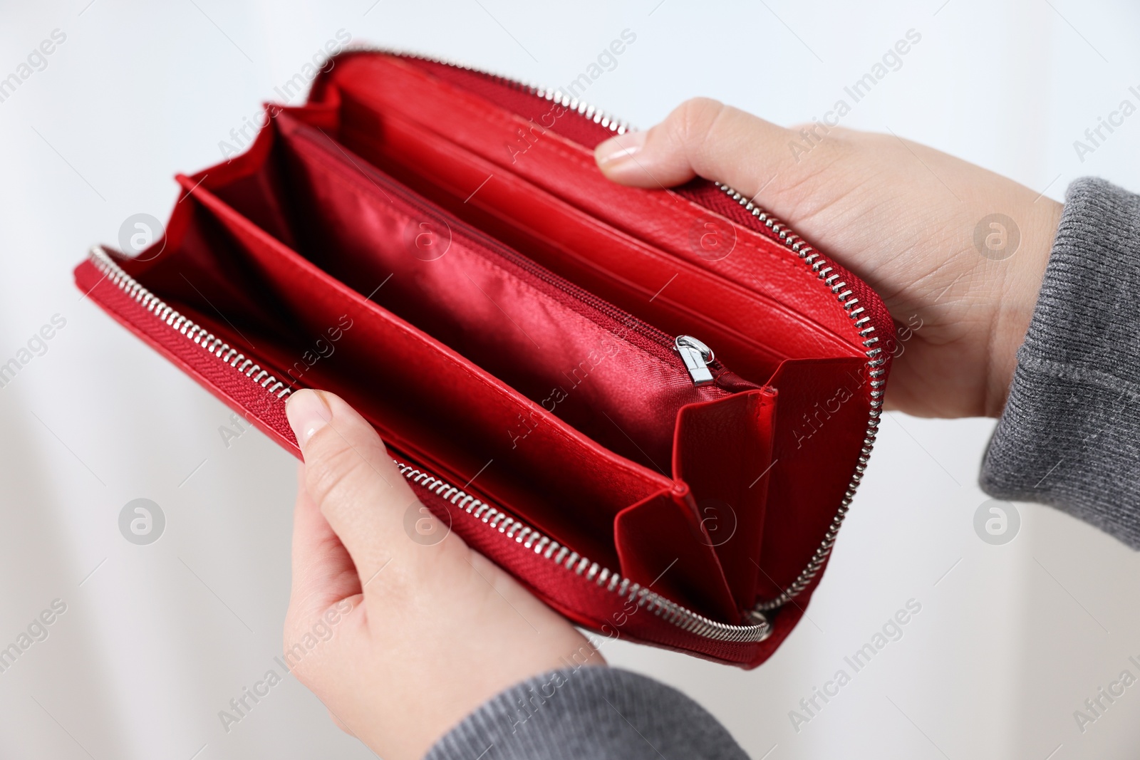 Photo of Woman with empty wallet indoors, closeup view