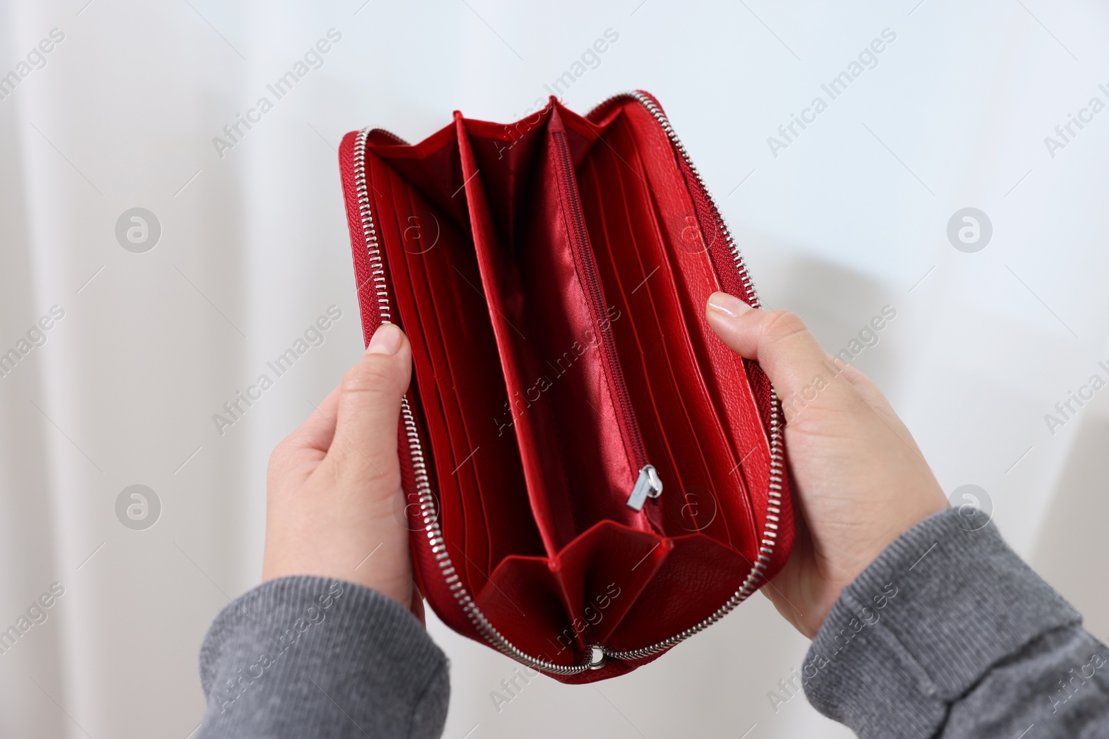 Photo of Woman with empty wallet indoors, closeup view