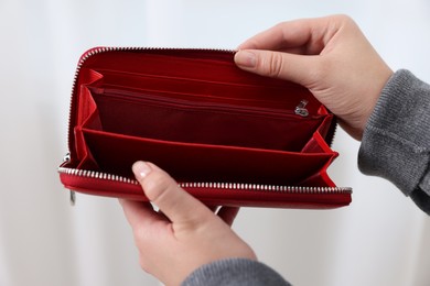 Photo of Woman with empty wallet indoors, closeup view