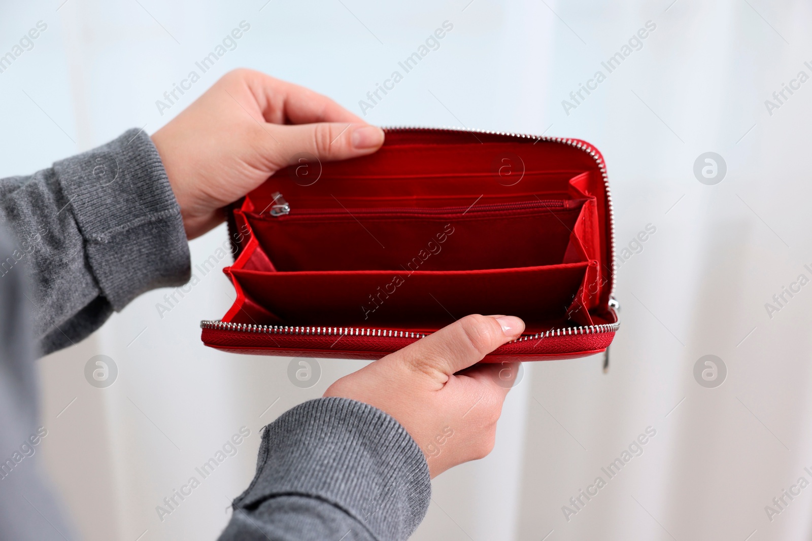 Photo of Woman with empty wallet indoors, closeup view