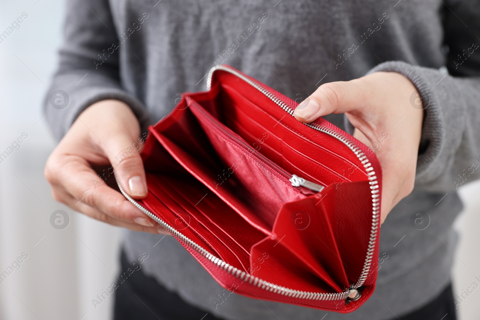 Photo of Woman with empty wallet indoors, closeup view