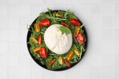 Photo of Delicious burrata salad on white tiled table, top view