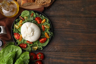 Photo of Delicious burrata salad and products on wooden table, flat lay. Space for text