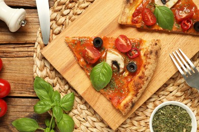 Photo of Flat lay composition of tasty pizza with basil, olives and tomato on wooden table