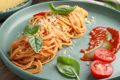 Photo of Delicious pasta with tomato sauce, basil and cheese on table, closeup