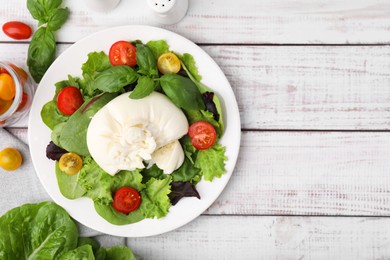 Photo of Delicious fresh burrata salad on white wooden table, flat lay. Space for text