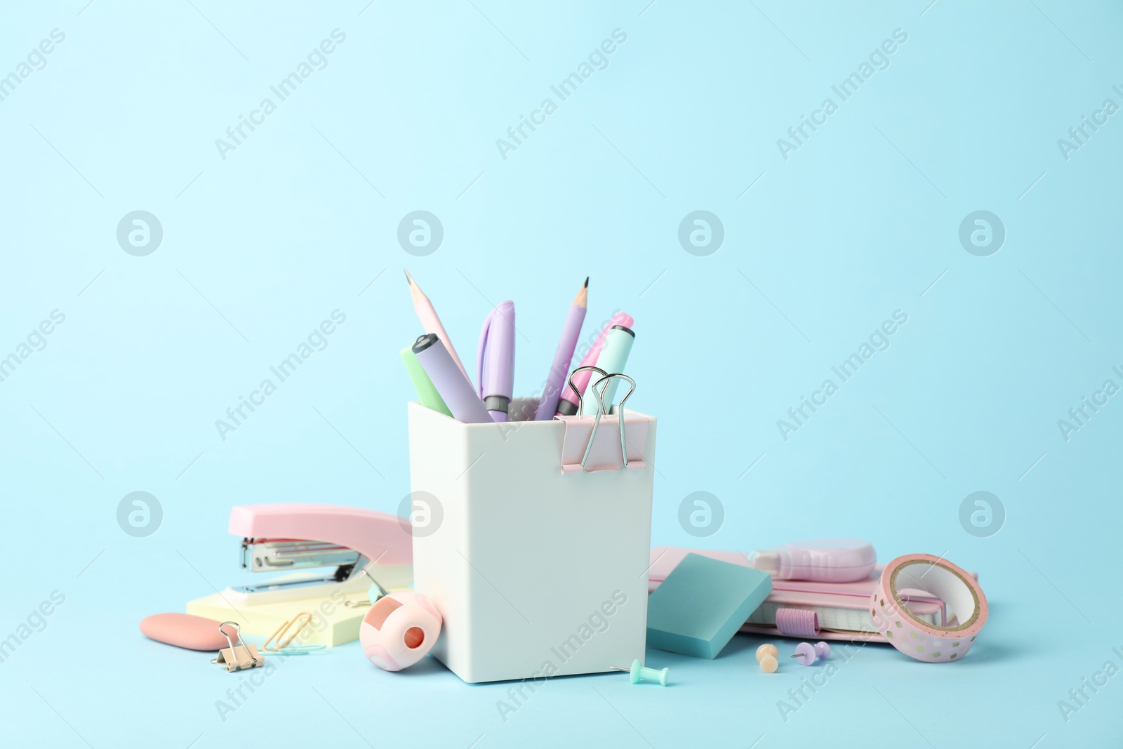 Photo of Stapler and other stationery on light blue background