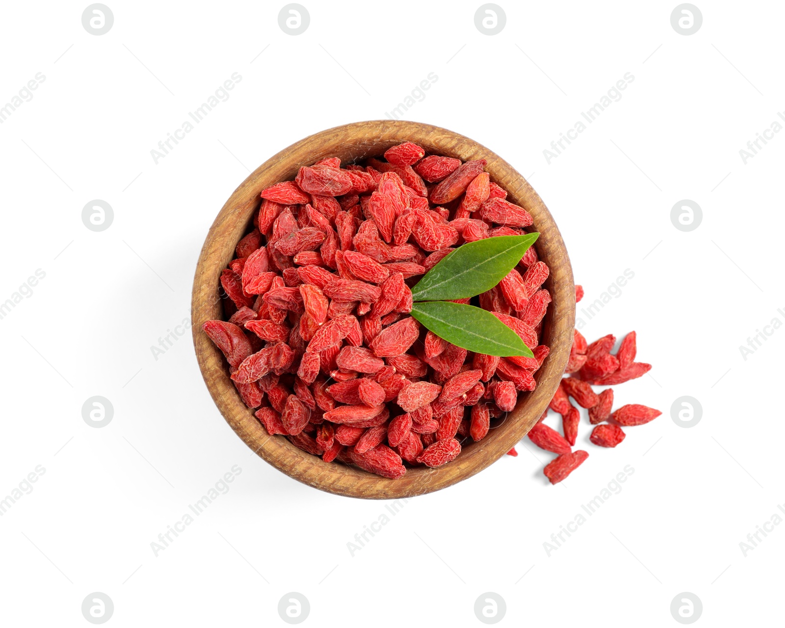 Photo of Dried goji berries in bowl and green leaves isolated on white, top view