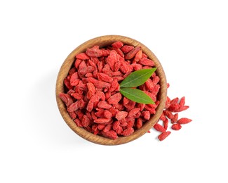 Photo of Dried goji berries in bowl and green leaves isolated on white, top view