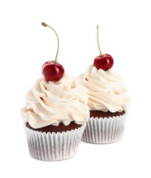 Delicious cupcakes with cream and cherries isolated on white