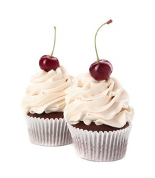 Photo of Delicious cupcakes with cream and cherries isolated on white