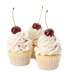 Delicious cupcakes with cream and cherries isolated on white