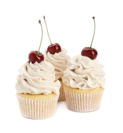 Photo of Delicious cupcakes with cream and cherries isolated on white