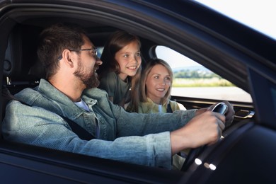 Happy family enjoying trip together by car, view from outside