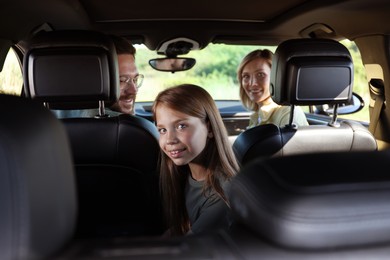 Happy family enjoying trip together by car, view from inside