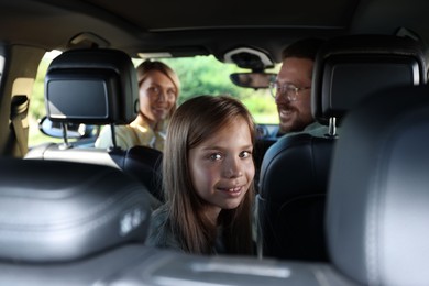 Happy family enjoying trip together by car, view from inside