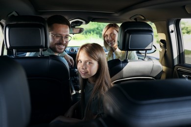 Happy family enjoying trip together by car, view from inside