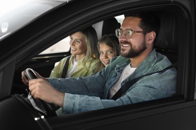 Happy family enjoying trip together by car, view from outside