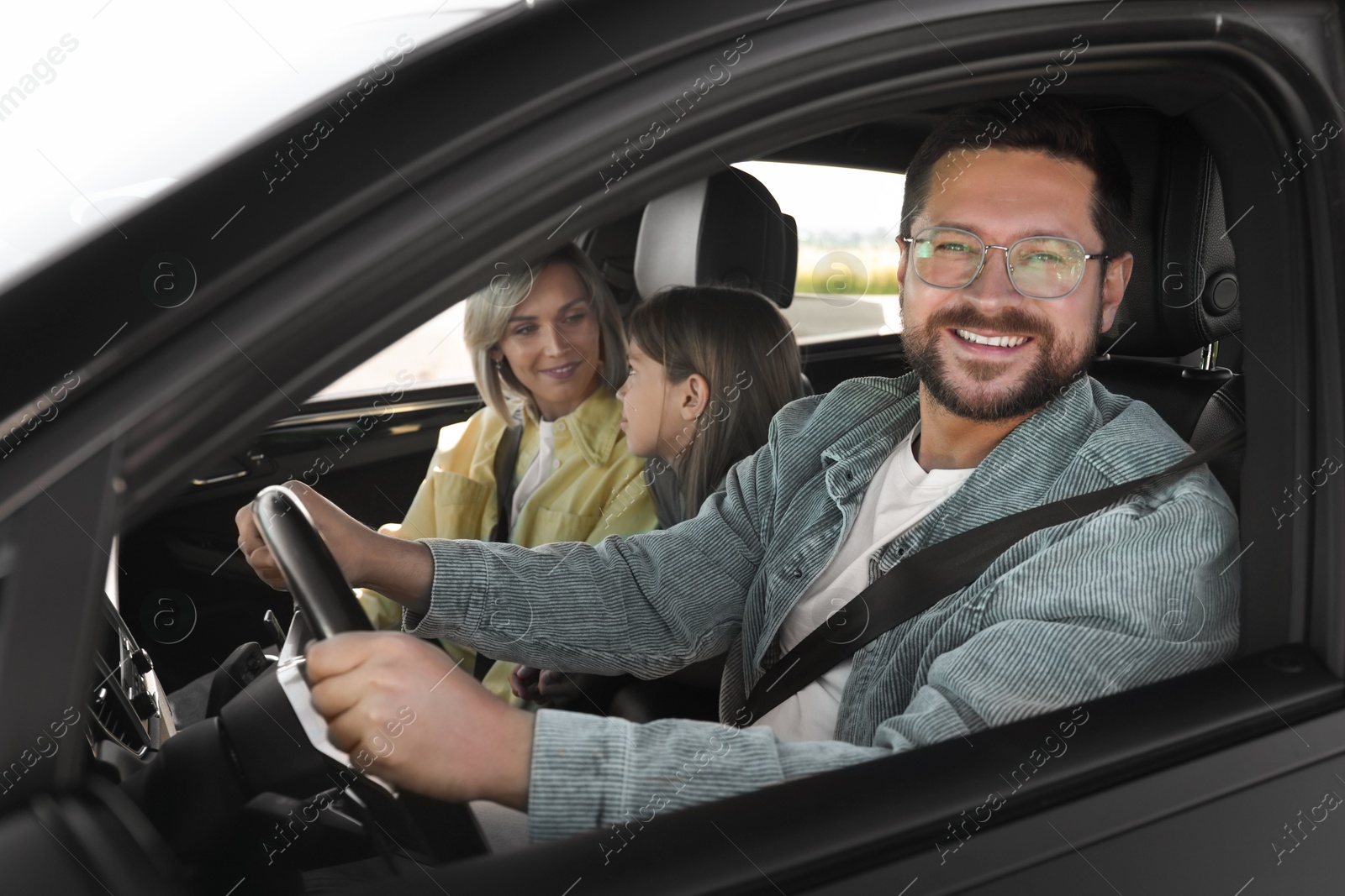 Photo of Happy family enjoying trip together by car, view from outside