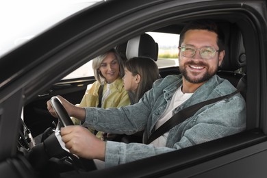 Happy family enjoying trip together by car, view from outside