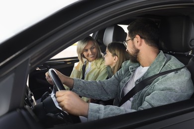 Photo of Happy family enjoying trip together by car, view from outside