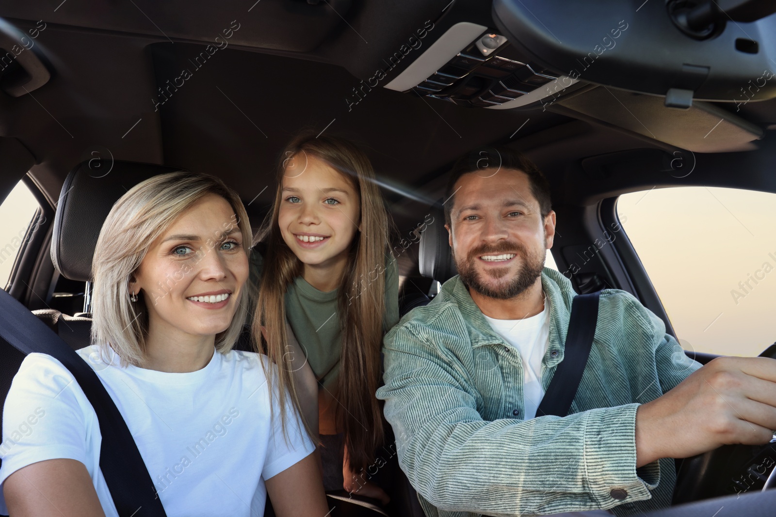 Photo of Happy family enjoying trip together by car, view from inside