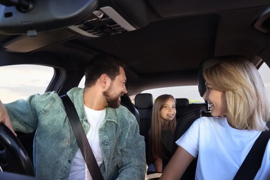 Photo of Happy family enjoying trip together by car, view from inside