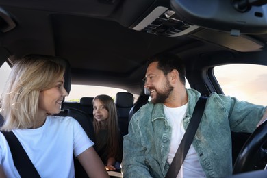 Photo of Happy family enjoying trip together by car, view from inside