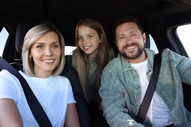 Happy family enjoying trip together by car, view from inside