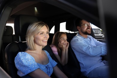 Happy family enjoying trip together by car, view from outside